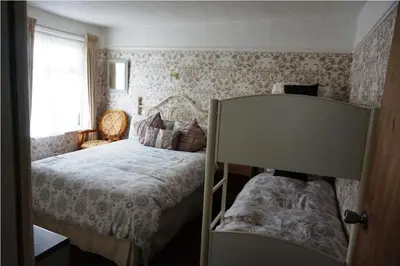 a small bedroom with a bed and a window at Dunromin Hotel in Blackpool