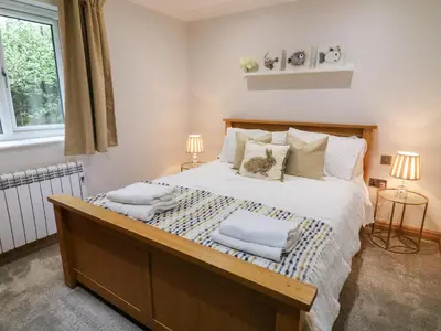 a bedroom with a large bed with towels on it at 2 Bedroom Annexe in Morecambe