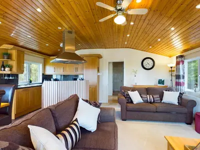 a living room with two couches and a kitchen at 3 Bedroom Lakeview Lodge - Ensuite & Balcony Deck in Carnforth