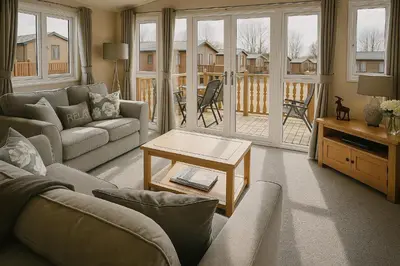 a living room with a couch and a table at Birch Lodge in Carnforth