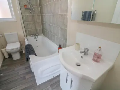a bathroom with a sink and a tub and a toilet at Birch Lodge in Carnforth