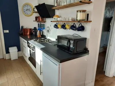 a kitchen with a counter with a microwave on it at 2 bed apartment 5min from sea in bare Morecombe in Morecambe