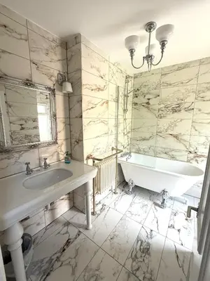 a white bathroom with a tub and a sink at Victorian Villa close to Liverpool City Centre in Liverpool