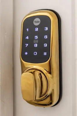 a gold door handle with a cell phone on it at The Adonis Hotel in Blackpool