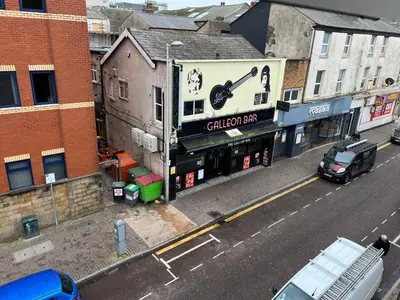 a building with a sign on the side of a street at Peaky blinders apartment 5 min walk to Blackpool tower sleeps up to 14 in Blackpool