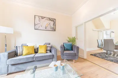 a living room with a couch and a chair at *KING BED* LUXURY CITY CENTRE HOUSE in Barrow in Furness