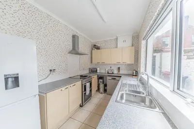 a kitchen with a sink and a large window at *KING BED* LUXURY CITY CENTRE HOUSE in Barrow in Furness