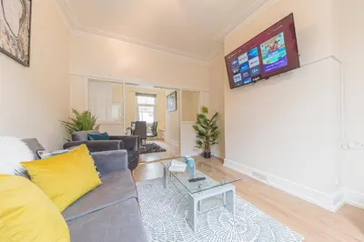 a living room with a couch and a flat screen tv at *KING BED* LUXURY CITY CENTRE HOUSE in Barrow in Furness