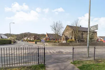 an empty street with a gate in front of a house at Mayfair in Wigan