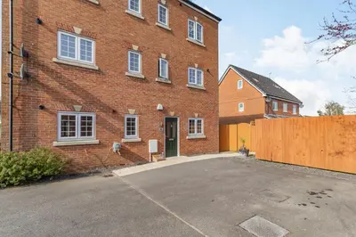 a brick building with a parking lot in front of it at Mayfair in Wigan