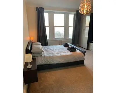 a bedroom with a bed with a large window at Marley Mansions Apartment - Egremont Promenade - 42 in Wallasey