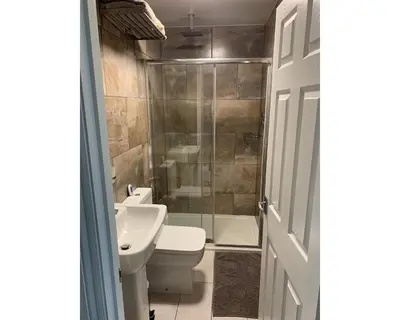 a bathroom with a toilet and a sink and a shower at Marley Mansions Apartment - Egremont Promenade - 42 in Wallasey