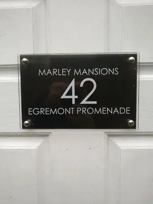 a sign on a door that reads marley mansions experiment prominent at Marley Mansions Apartment - Egremont Promenade - 42 in Wallasey