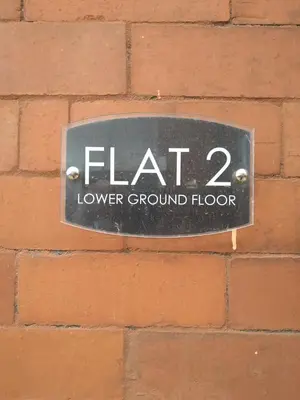 a sign on the side of a brick wall at Marley Mansions Apartment - Egremont Promenade - 42 in Wallasey