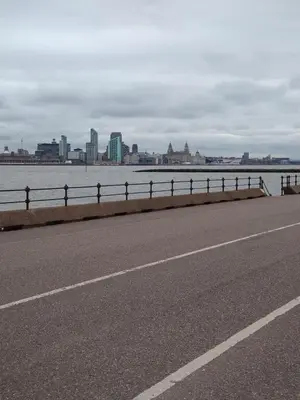 a road next to a body of water with a city at Marley Mansions Apartment - Egremont Promenade - 42 in Wallasey