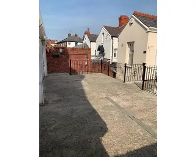 a view of a driveway with houses and a fence at Marley Mansions Apartment - Egremont Promenade - 42 in Wallasey