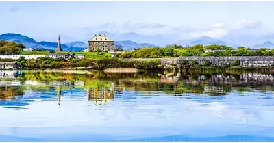 a large body of water with a building in the background at Herdwicks in Millom
