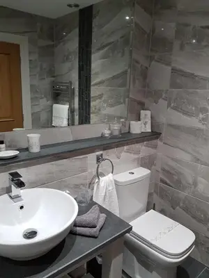 a bathroom with a sink and a toilet at Herdwicks in Millom