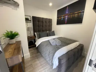 a bedroom with a bed with two pillows on it at Osborne hot tub and jacuzzi suites in Blackpool