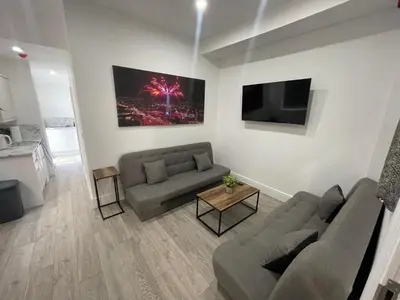 a living room with two couches and a tv at Osborne hot tub and jacuzzi suites in Blackpool