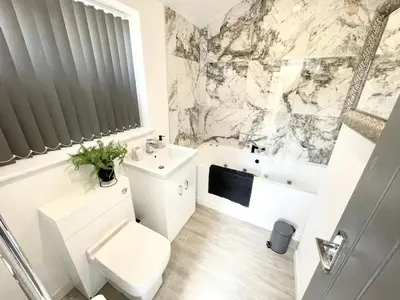 a bathroom with a toilet and a sink and a tub at Osborne hot tub and jacuzzi suites in Blackpool
