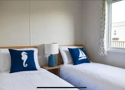 two beds sitting next to each other in a bedroom at 2 Bed - Sleeps 6 - 15min Walk to Beach in Morecambe
