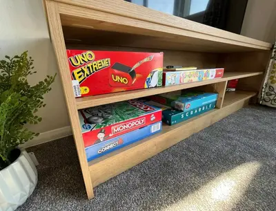 a book shelf filled with games and books at 2 Bed - Sleeps 6 - 15min Walk to Beach in Morecambe