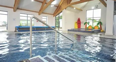 a indoor swimming pool with a hot tub at 2 Bed - Sleeps 6 - 15min Walk to Beach in Morecambe