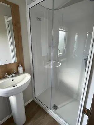 a bathroom with a shower and a sink at 2 Bed - Sleeps 6 - 15min Walk to Beach in Morecambe