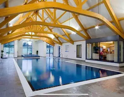 a swimming pool in a building with wooden beams at 2 Bed - Sleeps 6 - 15min Walk to Beach in Morecambe