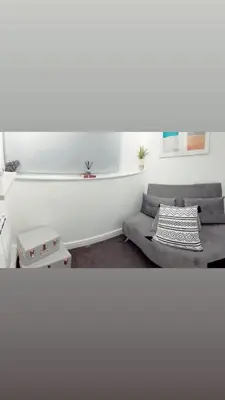 a living room with a couch and a table at Ivy Chic Apartments by CityNest in Blackpool