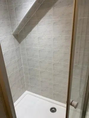 a shower with a glass door in a bathroom at Delamere ground floor holiday flat in Blackpool