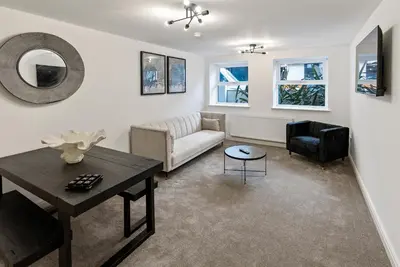 a living room with a couch and a table at Mode Apartments Winter Gardens Blackpool in Blackpool