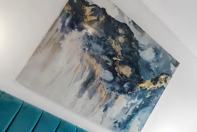 a painting of a mountain on a wall at Mode Apartments Winter Gardens Blackpool in Blackpool