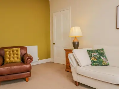a living room with a couch and a chair at Crow's Nest in Carnforth