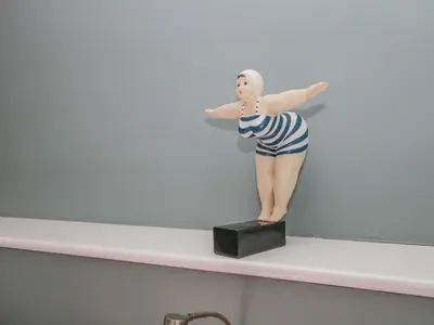 a figurine of a woman standing on a shelf at Crow's Nest in Carnforth