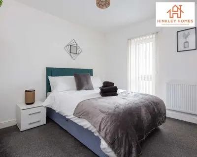 a bedroom with a large bed with a green headboard at Modern Townhouse - Free Gated Parking - City Centre - 5 ! By Hinkley Homes Short Lets & Serviced Accommodation in Liverpool