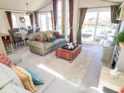 a living room with a couch and a table at Curlew Lodge in Carnforth