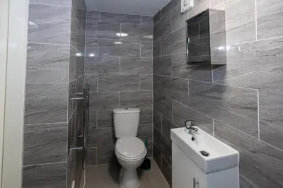 a bathroom with a toilet and a sink at TCO Luxury House in Liverpool