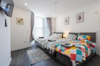a bedroom with a bed and a window at TCO Luxury House in Liverpool