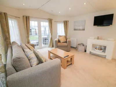 a living room with a couch and a fireplace at The Bobbin, Number 11 in Carnforth