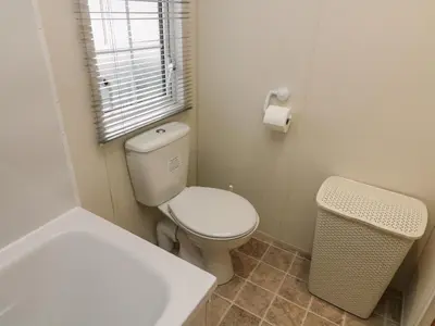 a bathroom with a toilet and a sink and a tub at The Bobbin, Number 11 in Carnforth