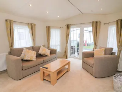 a living room with two couches and a coffee table at The Bobbin, Number 11 in Carnforth