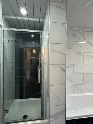 a shower with a glass door in a bathroom at Granada Apartments Derby Road in Blackpool