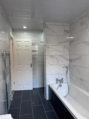 a bathroom with a tub and a sink and a shower at Granada Apartments Derby Road in Blackpool