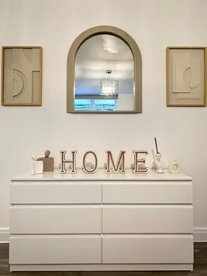 a white dresser with a home sign on it at Granada Apartments Derby Road in Blackpool