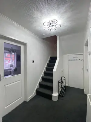 a staircase in a building with a stair case at NEW…THE HOTTUB HOUSE BLACKPOOL PLEASURE BEACH in Blackpool