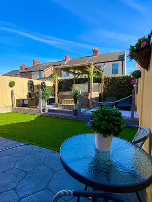 a table with a potted plant on a patio at NEW…THE HOTTUB HOUSE BLACKPOOL PLEASURE BEACH in Blackpool