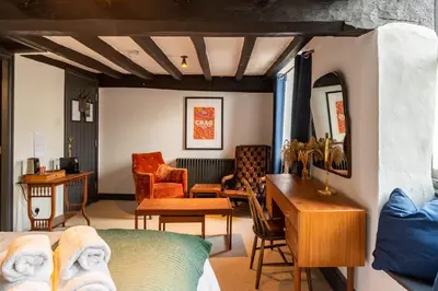 a room with a bed and a desk and a couch at Royal Oak Pub in Cartmel