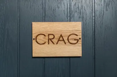 a sign that says crap on a wooden door at Royal Oak Pub in Cartmel